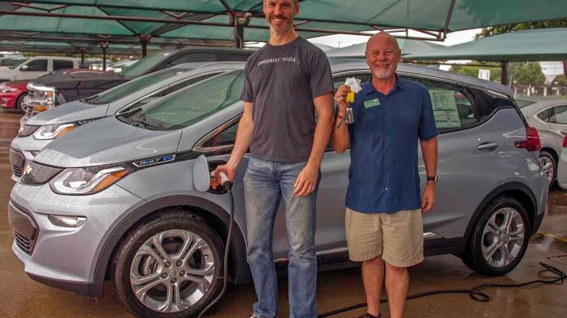 Craig Boland (left) takes delivery of one of the first 2017 Bolt EVs in Texas from Richard D. "Buzz" Smith of Classic Chevrolet.