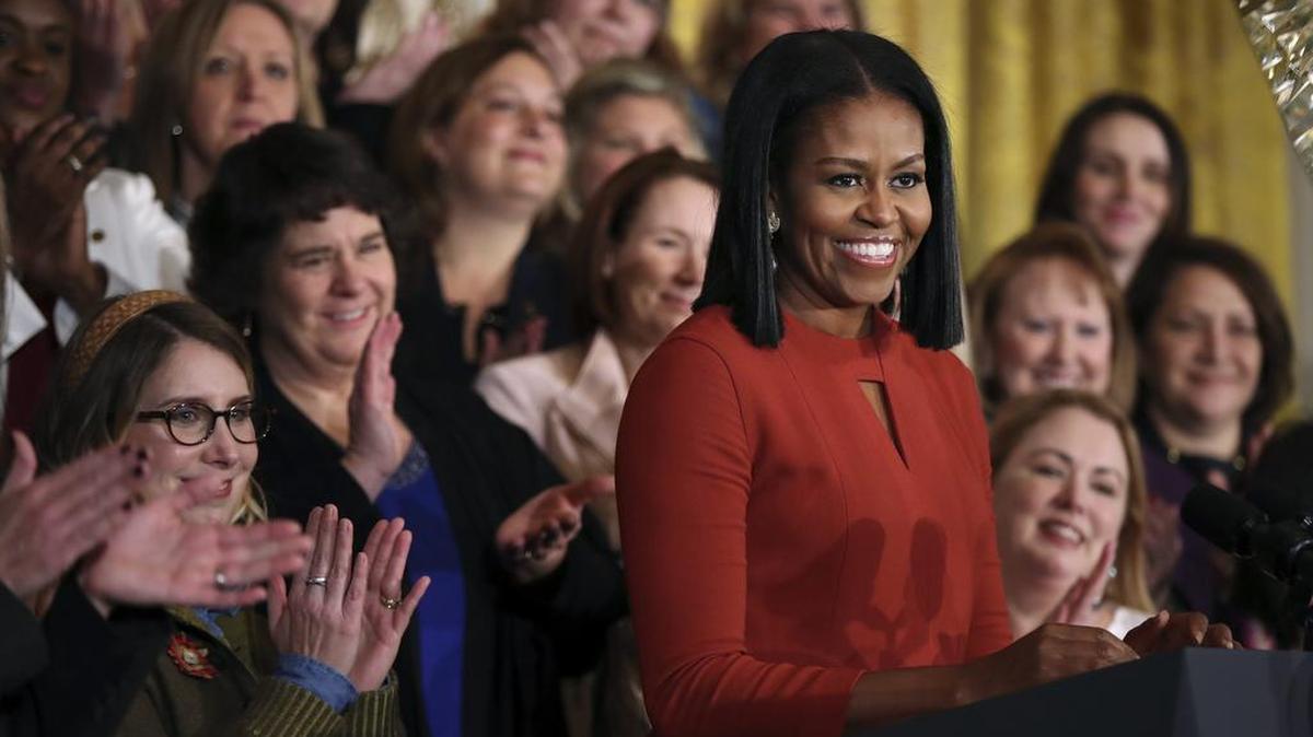 FILE- In this Jan. 6, 2017, file photo, first lady Michelle Obama smiles as she speaks at the 2017 School Counselor of the Year ceremony in the East Room of the White House in Washington.
