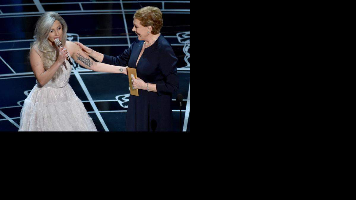 
Lady Gaga, left, and Julie Andrews speak at the Oscars on Sunday, Feb. 22, 2015, at the Dolby Theatre in Los Angeles. 

