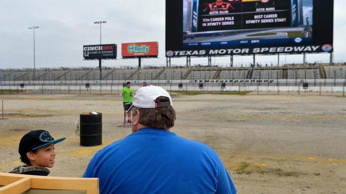 Brad Cox, Fort Worth, and his grandson Kalven Cox parked inside Texas Motor Speedway to watch the NASCAR XFINITY Series race on the Big Hoss TV in Fort Worth on Feb. 21, 2015.