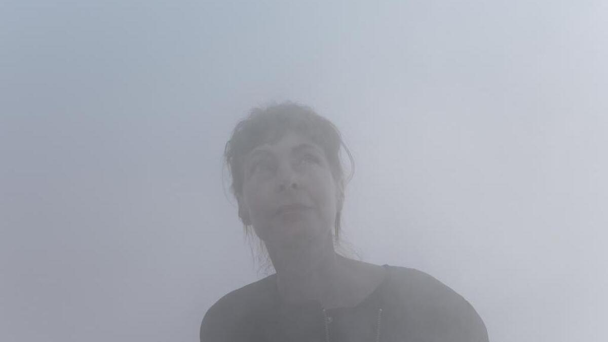 Artist Ann Veronica Janssens disappearing into her piece, Blue, Red and Yellow at the Nasher Sculpture Center in Dallas on Friday, Jan. 22, 2016.