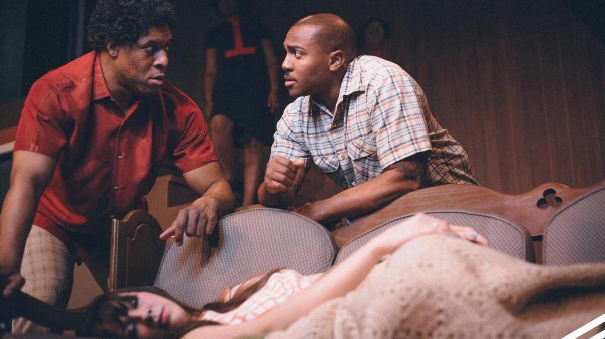 In “Detroit ’67,” Lank (Bryan Pitts), left, and Sly (Orlando Valentino) come to the aid of a beaten white woman, Caroline (Katreeva Phillips), and bring her home, leading to family discord.