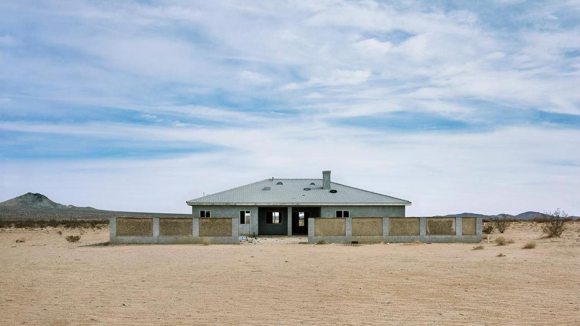 An abandoned home sits in an arid landscape in California City, California