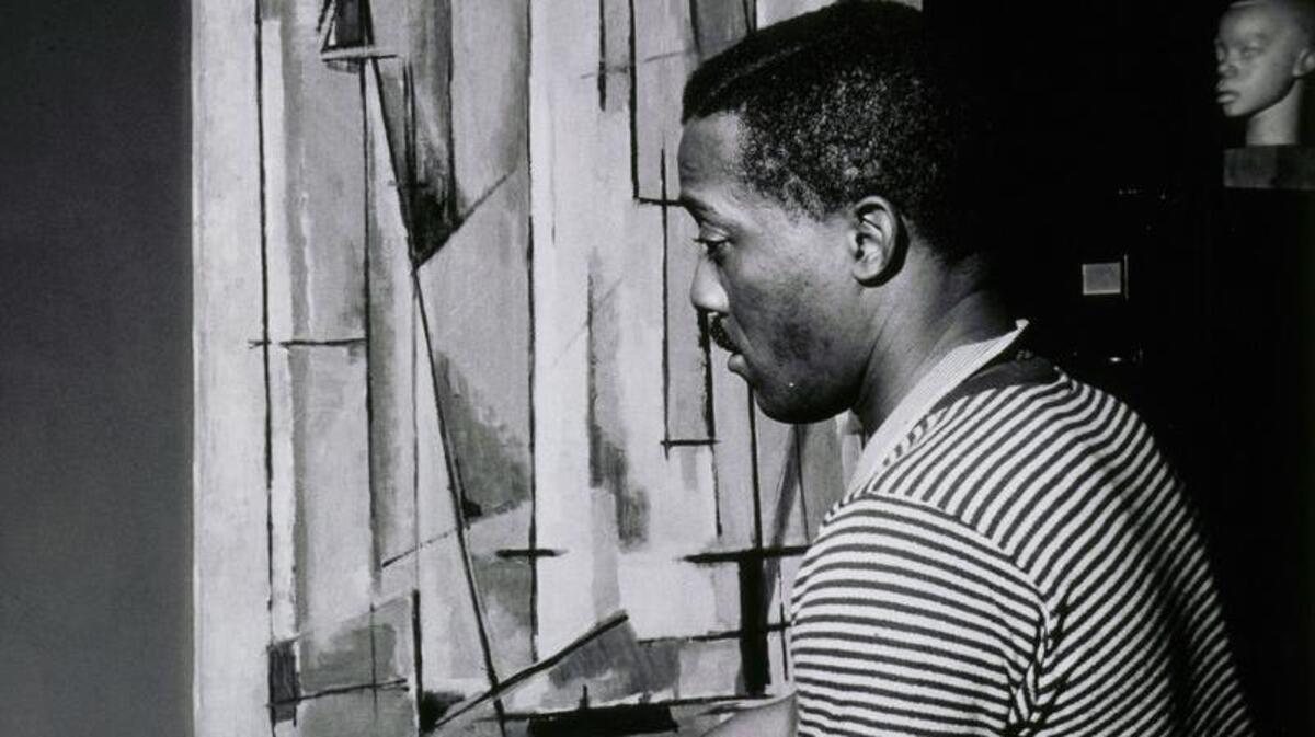 Lewis works on “Composition I” in 1945. The painting is on view in “Procession."
