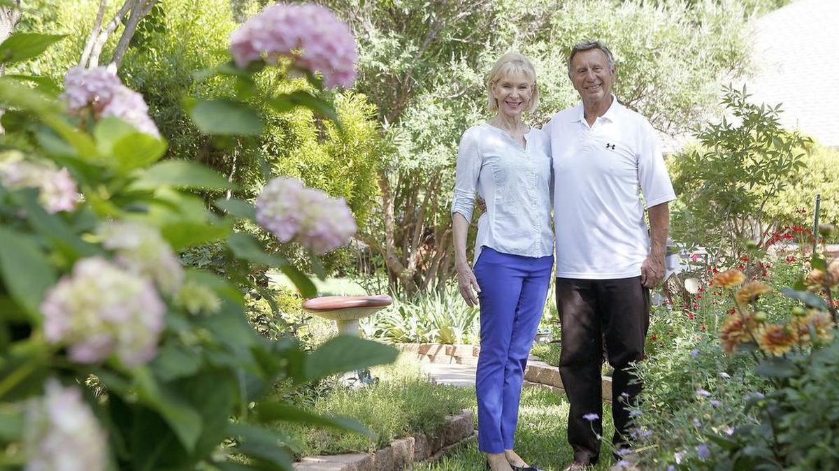 Dr. Robert Usseglio and Glenda Brooks stand amid the lovely landscaping at their home. They had a blank slate to work with when they moved to Fort Worth 13 years ago.