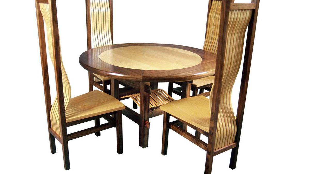 Round dining table set in ash and walnut from Earl Nesbitt Fine Furniture