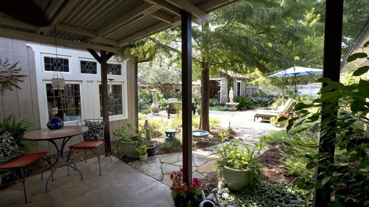 
The Euless garden of Kenneth and Jackie Cantrell includes an outdoor room that they use year-round.
