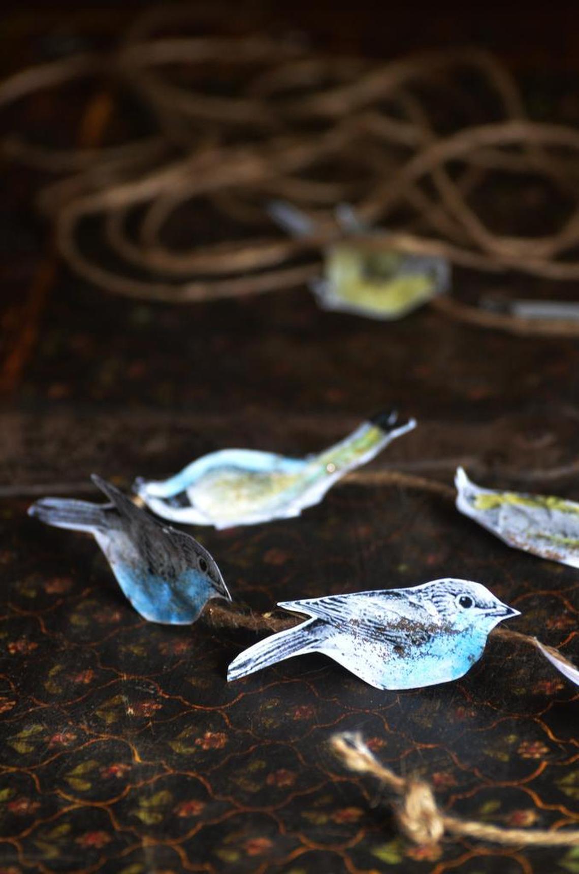 Paper birds on twine