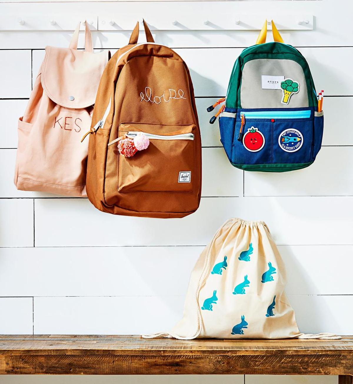 Make going back to school fun with these ideas for personalizing your child’s backpack. Clockwise, from left: Stitch your kids’ names; use stickers to dress up a backpack; or use a stencil that is meaningful to your little one.