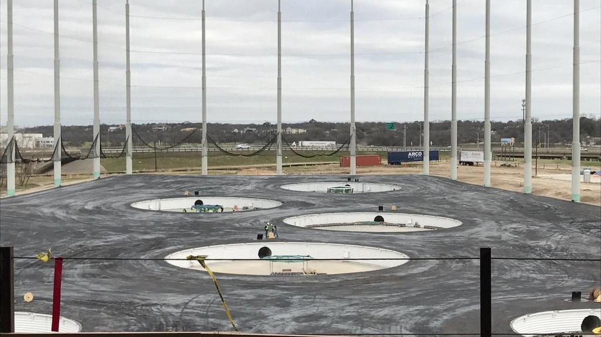 Players at Top Golf hit toward targets on the driving range to score points.