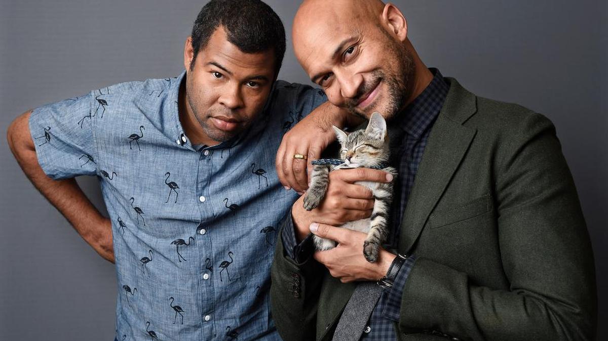 Jordan Peele, left, and Keegan-Michael Kay star — along with a cuddly co-star — in the movie Keanu.
