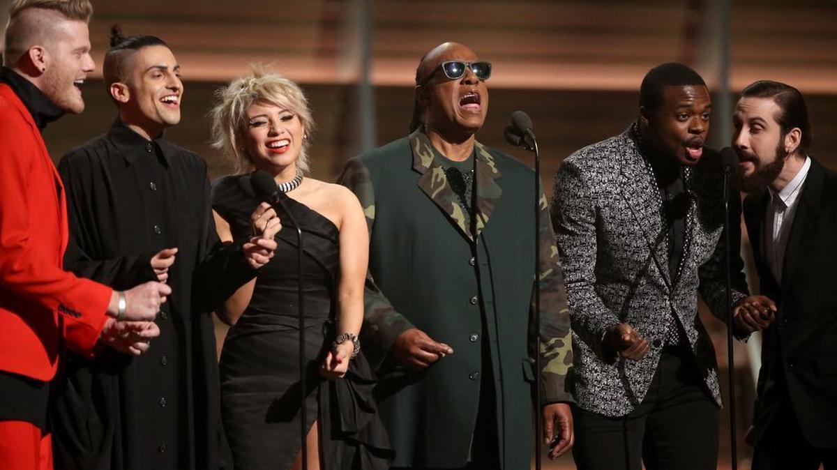 Stevie Wonder, center, and, from left, Scott Hoying, Mitch Grassi, Kirstin Maldonado, Kevin Olusola and Avi Kaplan of Arlington-formed Pentatonix sing a tribute to Maurice White of Earth, Wind & Fire.