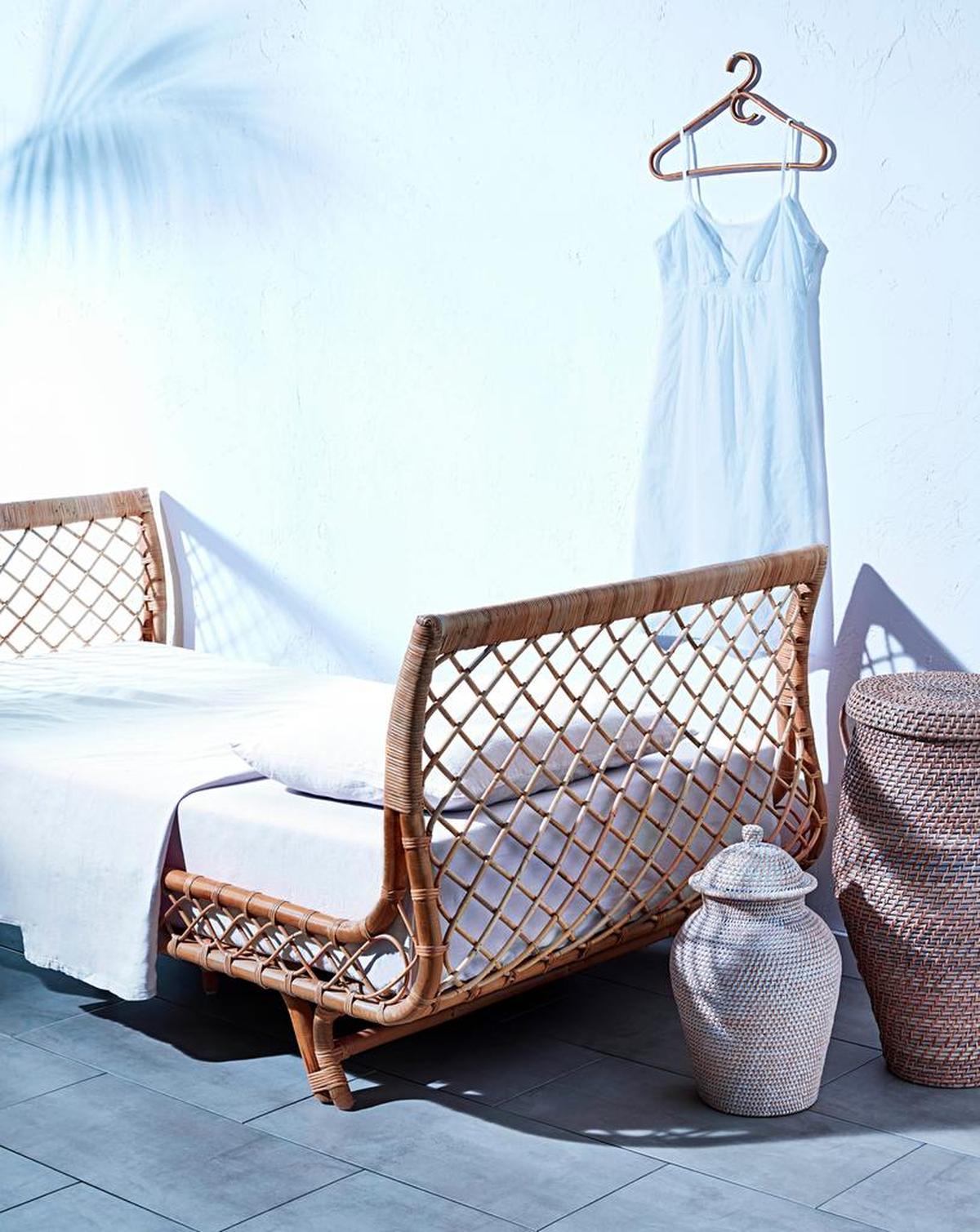 This daybed, along with the urn and jar at the foot of the bed, all have a cool, inviting elegance.