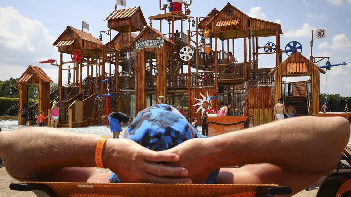 A guest relaxes in one of the one of the lounge chairs in the new water park addition in Paradise Springs at the Gaylord Texan Sunday.