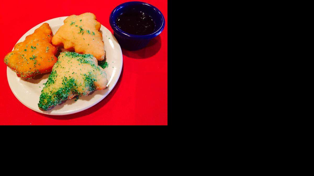 
El Fenix is serving Christmas tree-shaped sopaipillas with honey.

