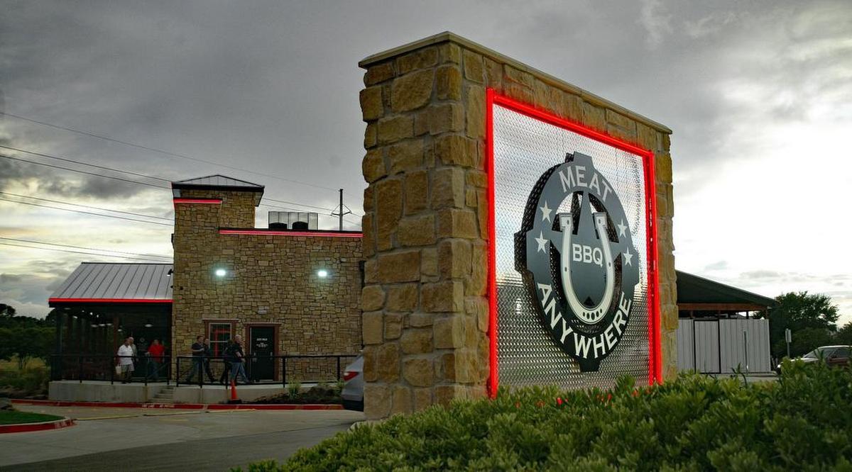 The red lighting of Meat U Anywhere has become a prominent fixture at the entrance to Trophy Club from Texas 114.