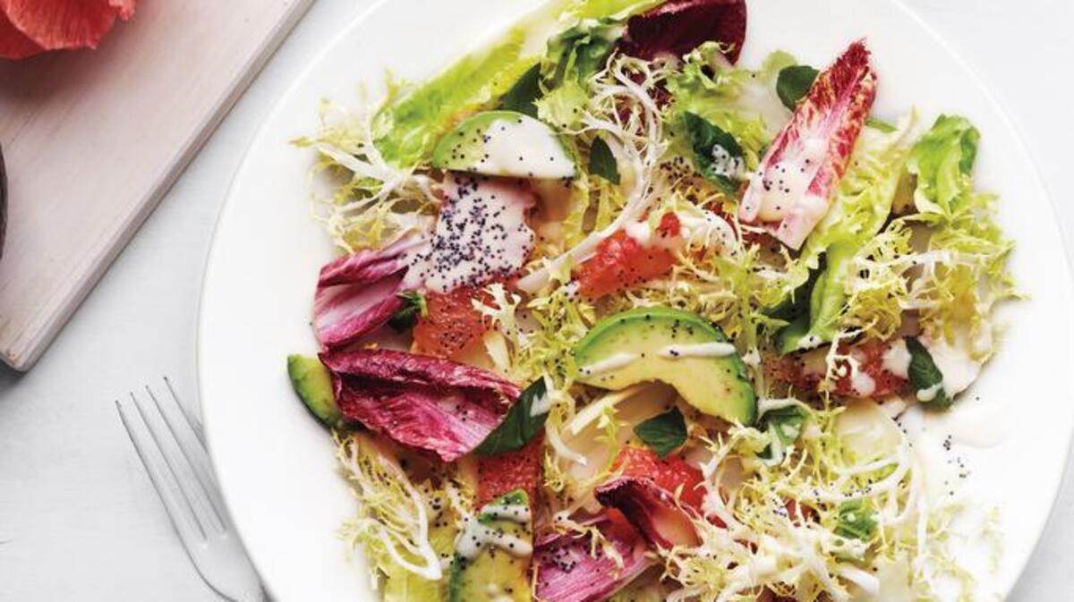 Greens related to chicory, sweet-tart grapefruit and avocado are tossed with a creamy vinaigrette and topped with poppy seeds.