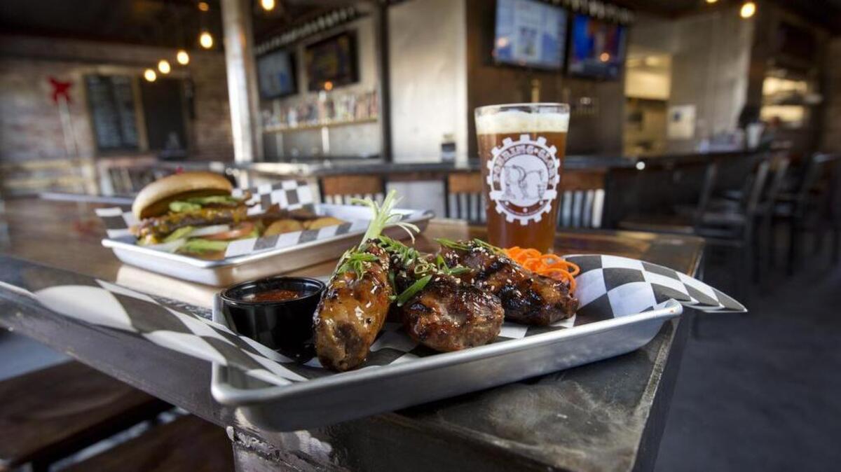 Thai tropic pork shank and avocado bacon burger at Pouring Glory Growler Fill Station & Grill in Fort Worth