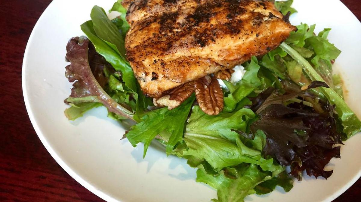 A house salad with blackened salmon, goat cheese and lots of pecans at FnG Eats in Keller.