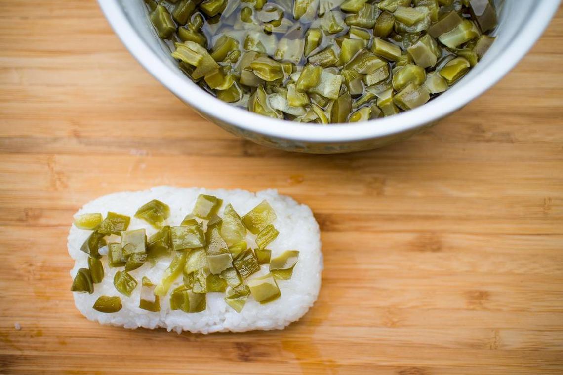 A tablespoon of pickled cactus goes between the rice block and fried Spam.