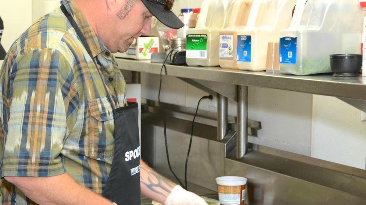Brian “Pig Man” Quaca slicing pork for a Hunt.Fish.Feed event