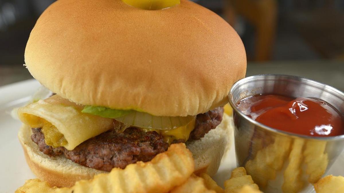 Burger topped with enchilada at Papa’s Smokehouse & Cantina.