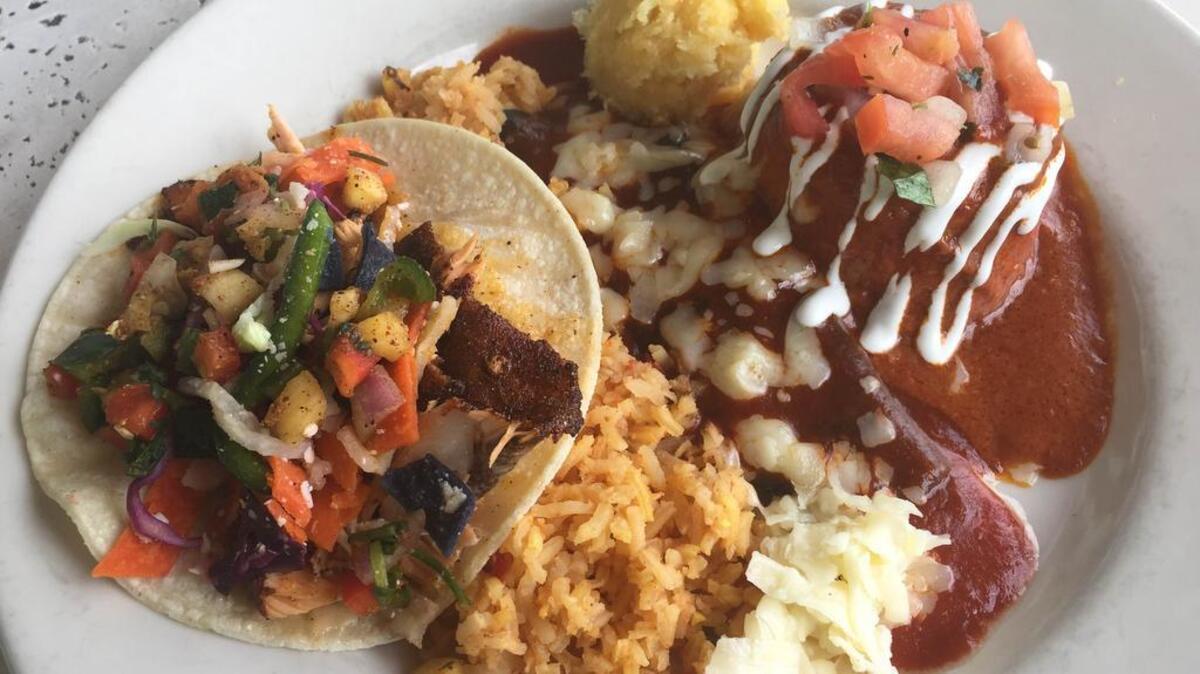 A lunch combo with a salmon taco, cheese enchilada and chicken adobe pie at Blue Mesa Grill.