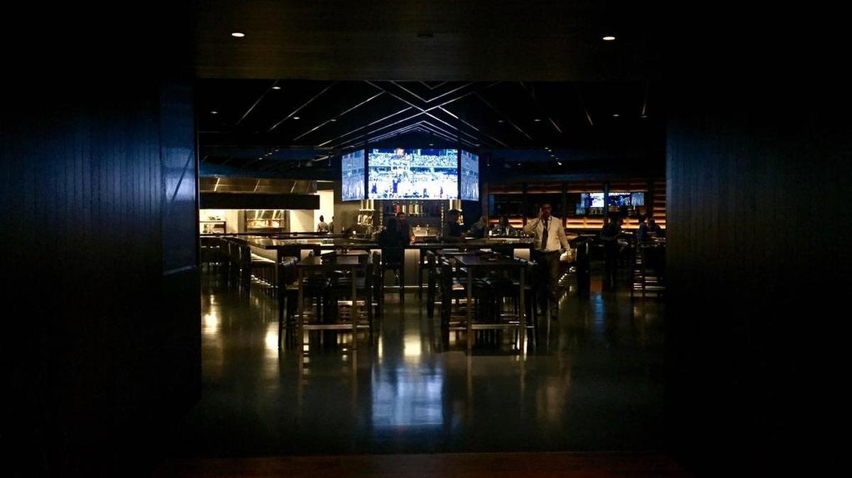 The cavernous Stadium Club was a dark sports grill with big TVs.