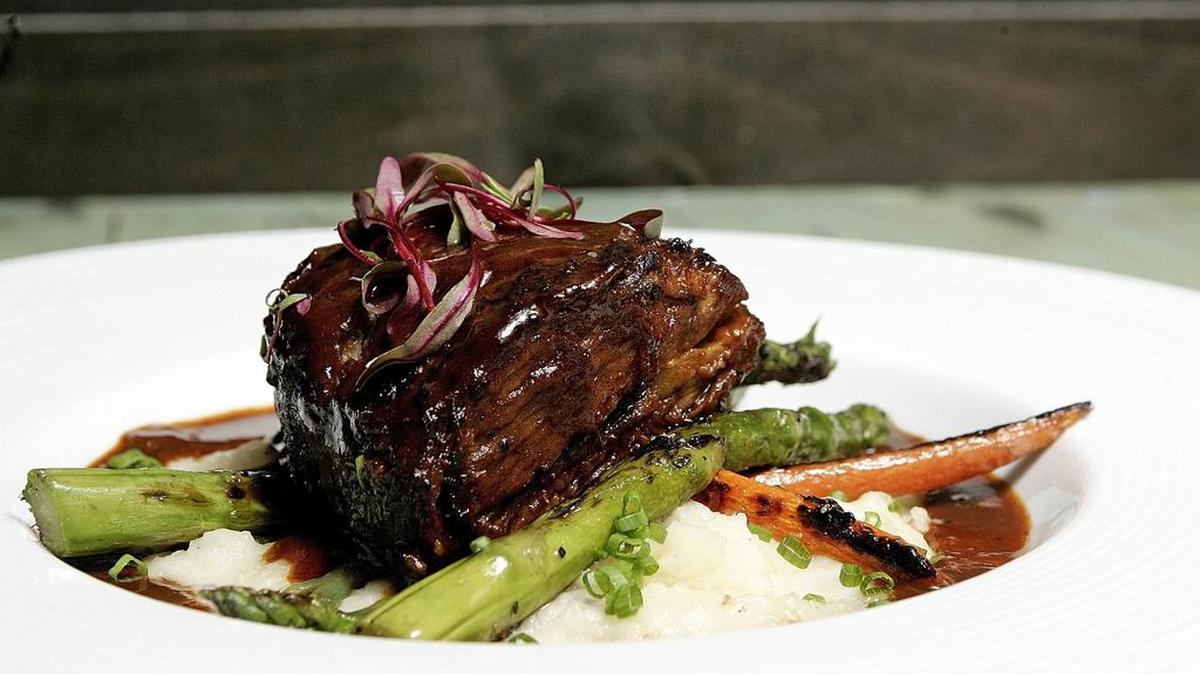 Braised Akaushi tri-tip with garlic mashed potatoes, cremini mushrooms, asparagus tips and carrots at Common Ground Grill & Tap in Fort Worth