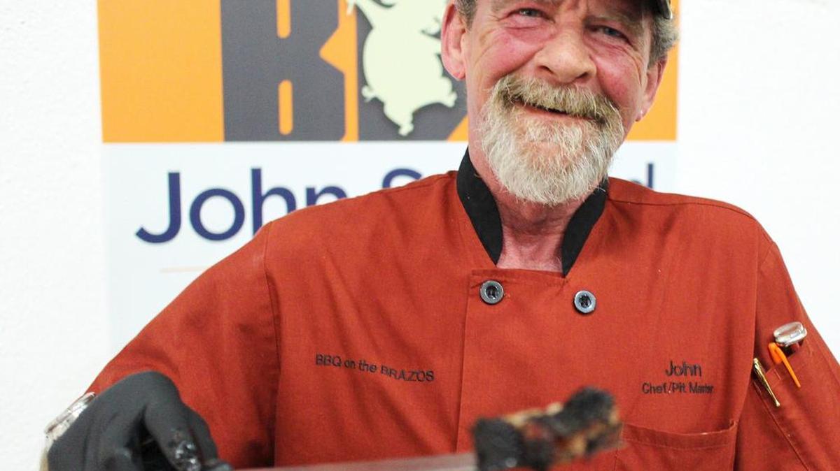 John Sanford, of BBQ on the Brazos, serves up brisket.