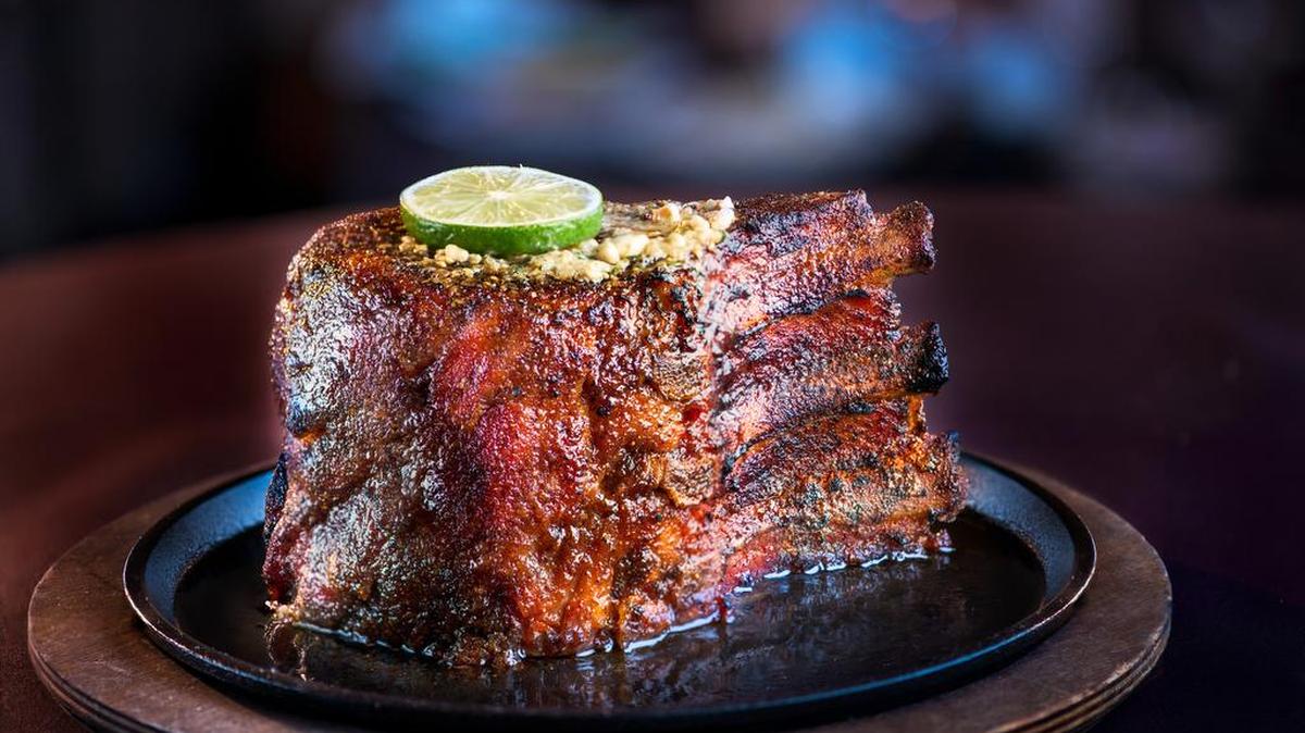The signature “seven-finger” pork chop, so called because it’s seven fingers thick, at Perry’s Steakhouse & Grille