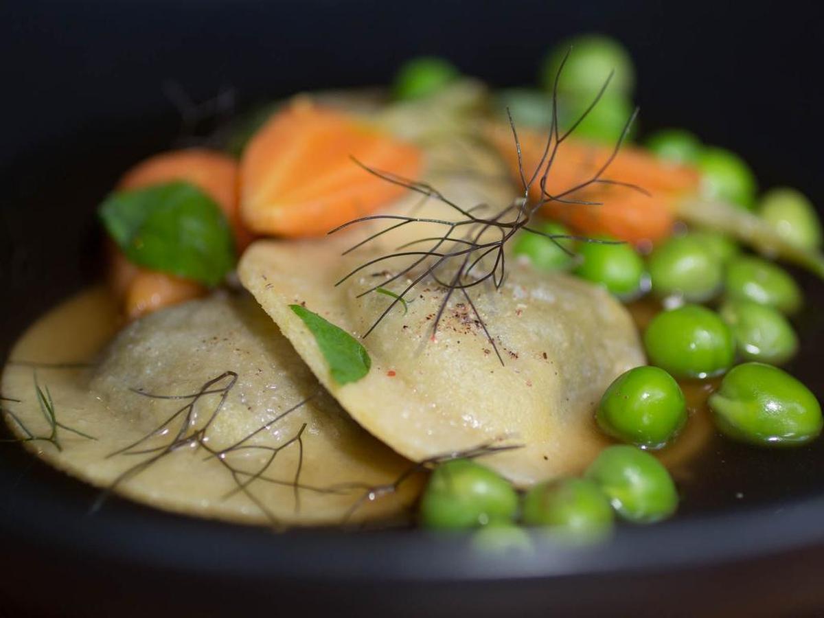 Duck-filled ravioli with baby carrots and freshly-shucked peas at On the Lamb in Dallas.