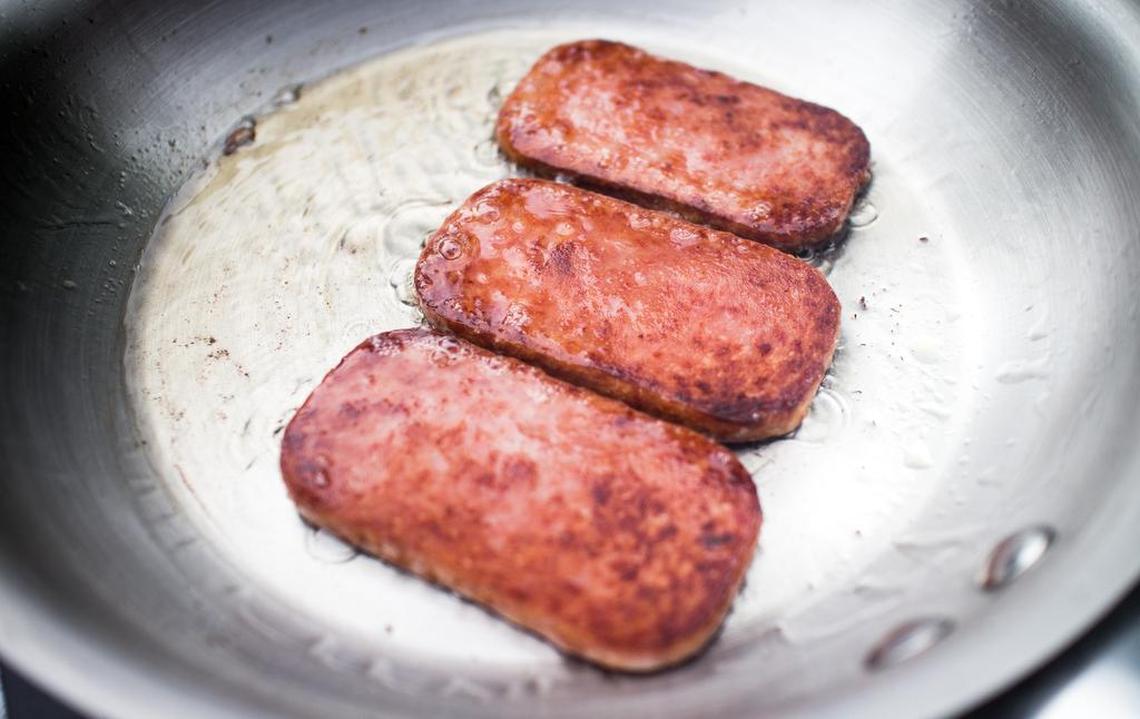 The secret to cooking spam is to slice it thin and fry it until it is crispy.