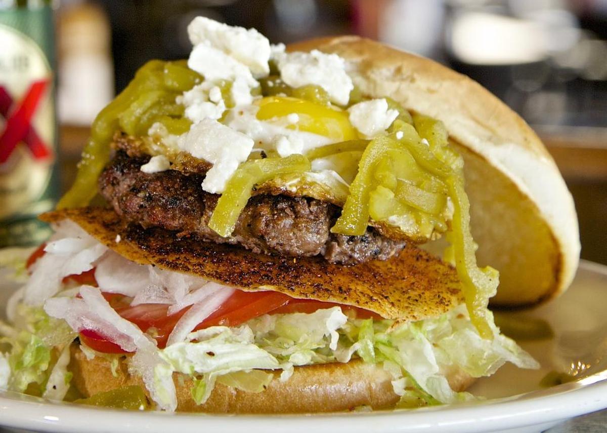 The Hatch chile enchilada burger is layered with classic toppings, plus tortillas, egg and more.