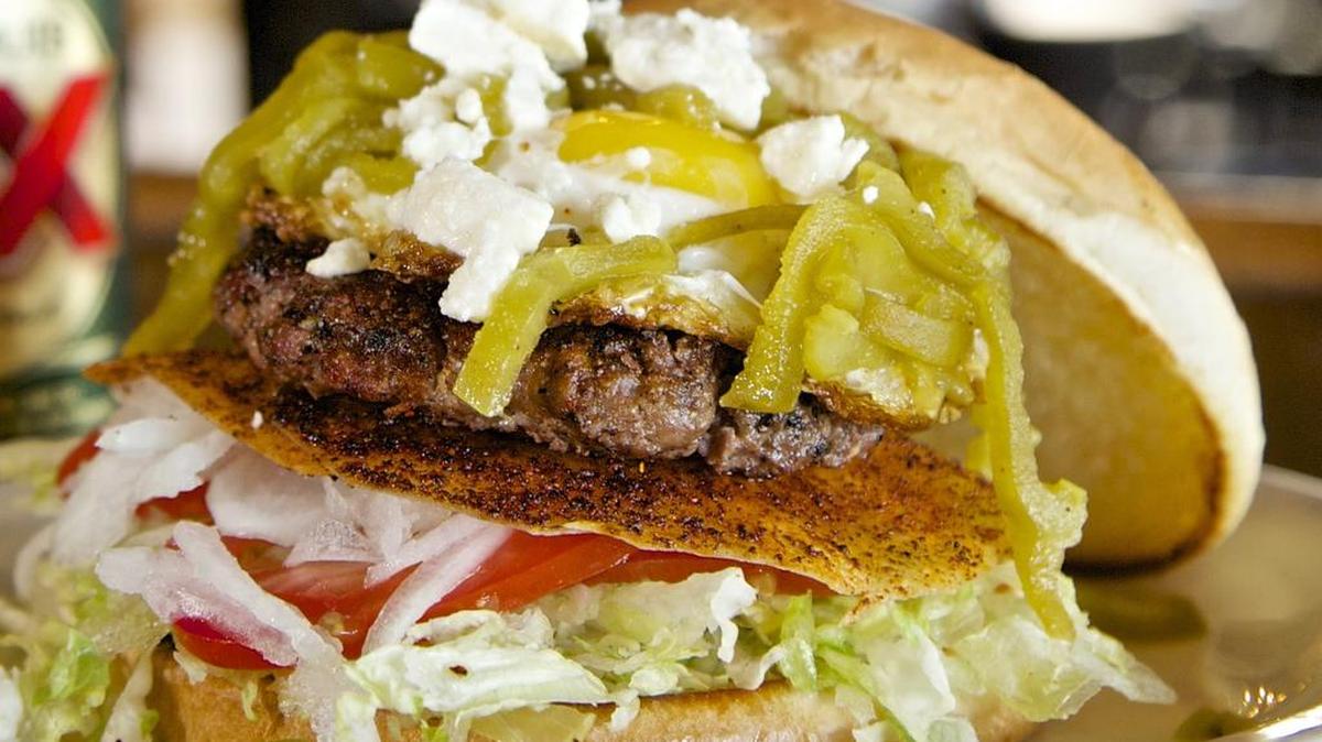 
The Hatch chile enchilada burger is layered with classic toppings, plus tortillas, egg and more.


