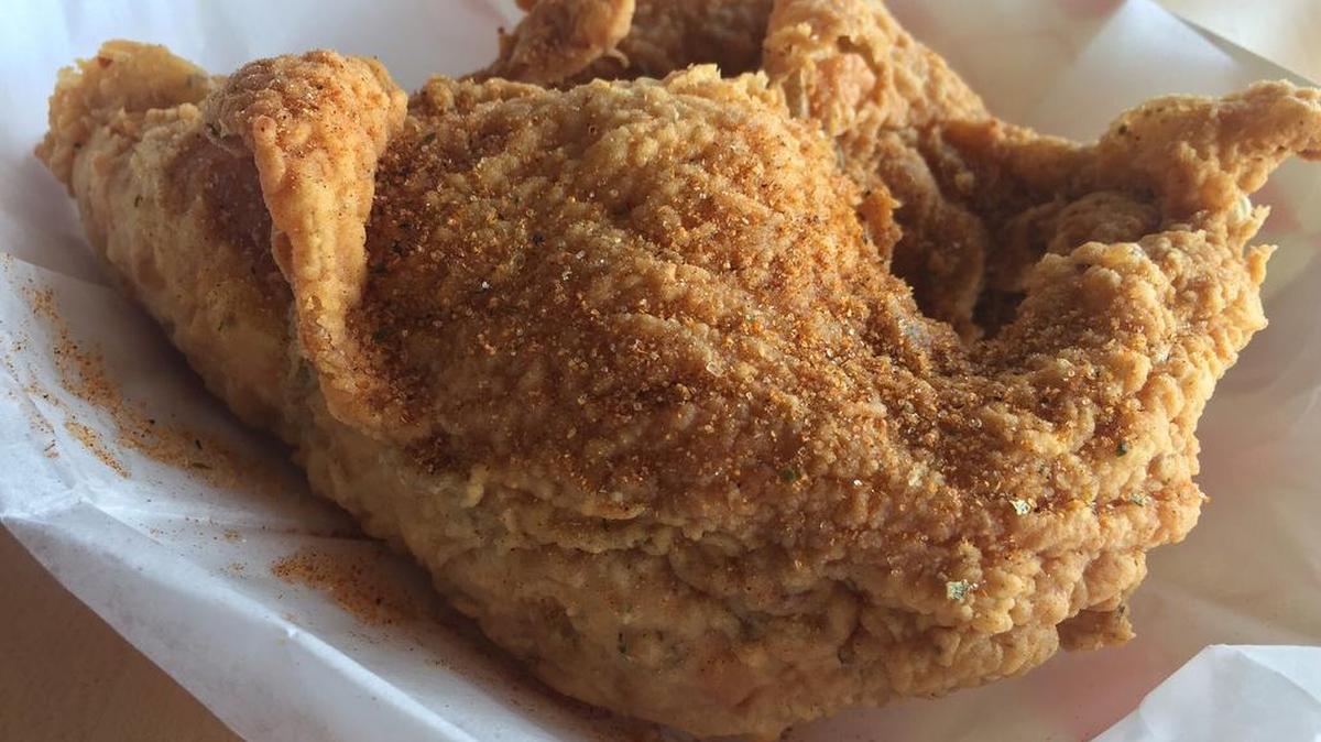A fried chicken breast dusted with spice “Texas-style” at Chicago’s Chicken Coop in Arlington.