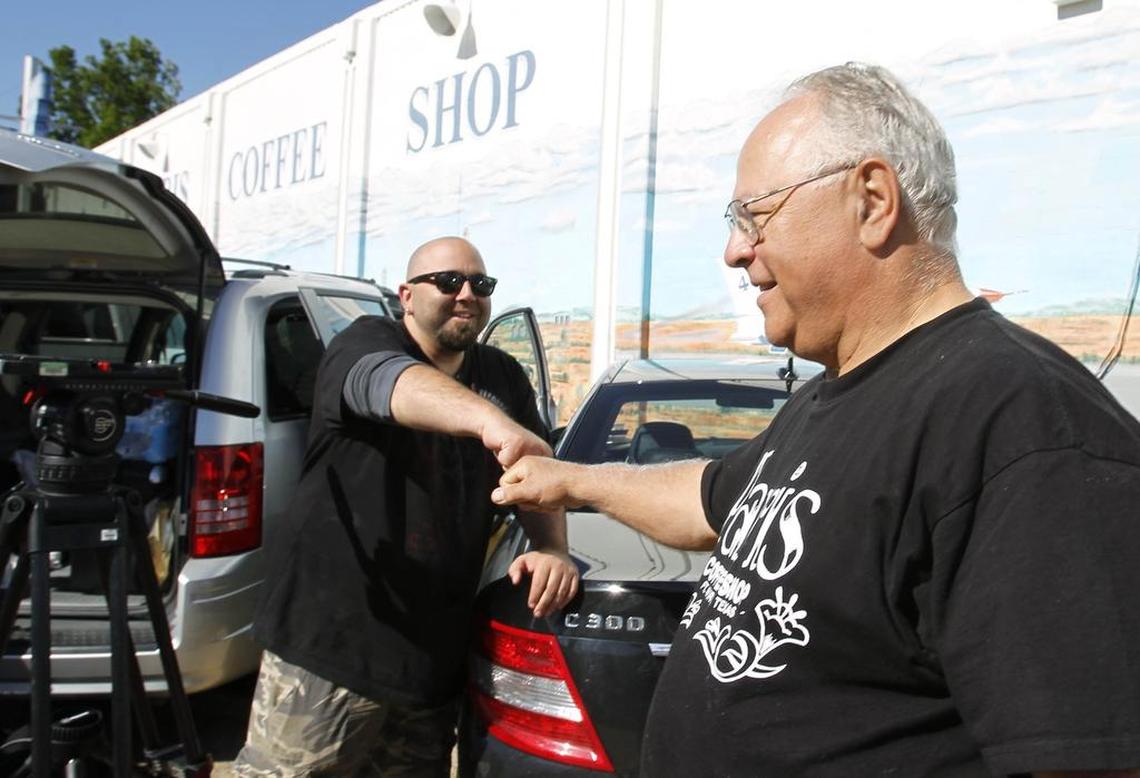 Food Network’s Duff Goldman of Ace of Cakes talks with Mike Smith (right), owner of the Paris Coffee Shop, after filming a 2011 segment.