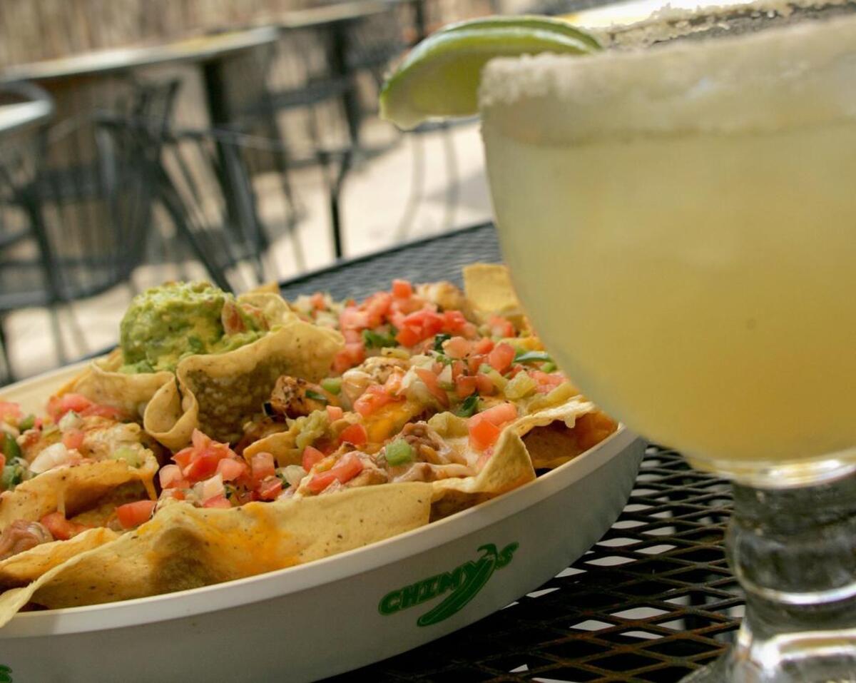 The green chile chicken nachos and a cold margarita on the patio at Chimy's. 