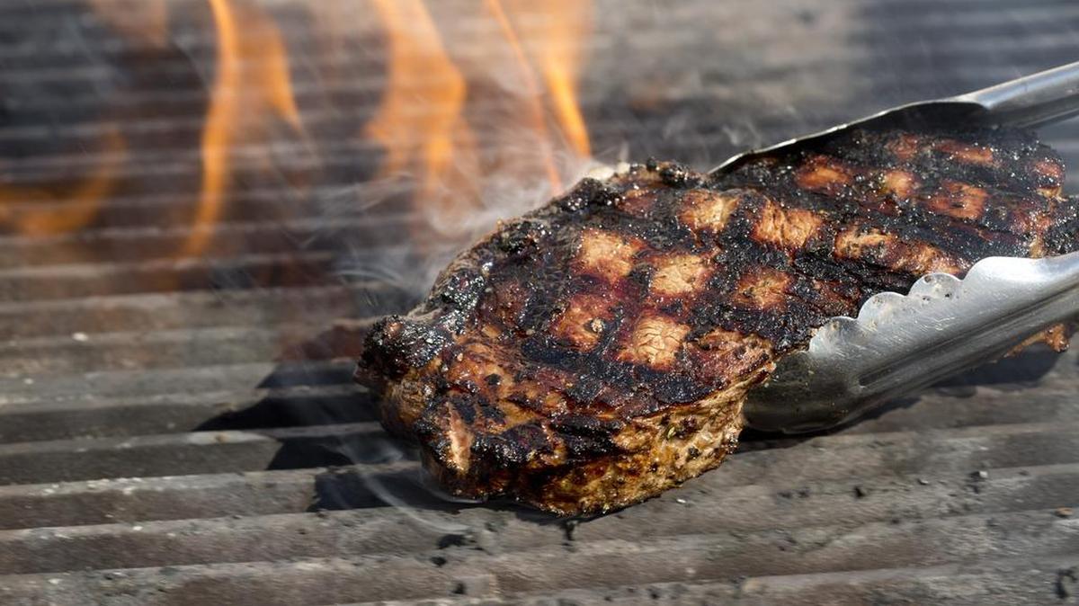 
Chef Lou Lambert grills steaks for charity at his Hunt & Fish Social Club.
