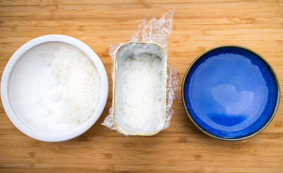 Half-cup of rice packed into the bottom of the Spam can. Keep a bowl of warm water handy to dip your hands into to keep the rice from sticking to your hands when handling the rice.