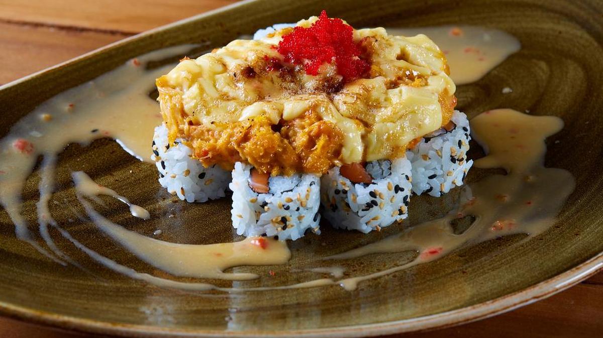 The “Volcano” sushi roll at Palladino’s Dos Jefes in Dallas: salmon, spicy crab, sesame chipotle aioli, masago