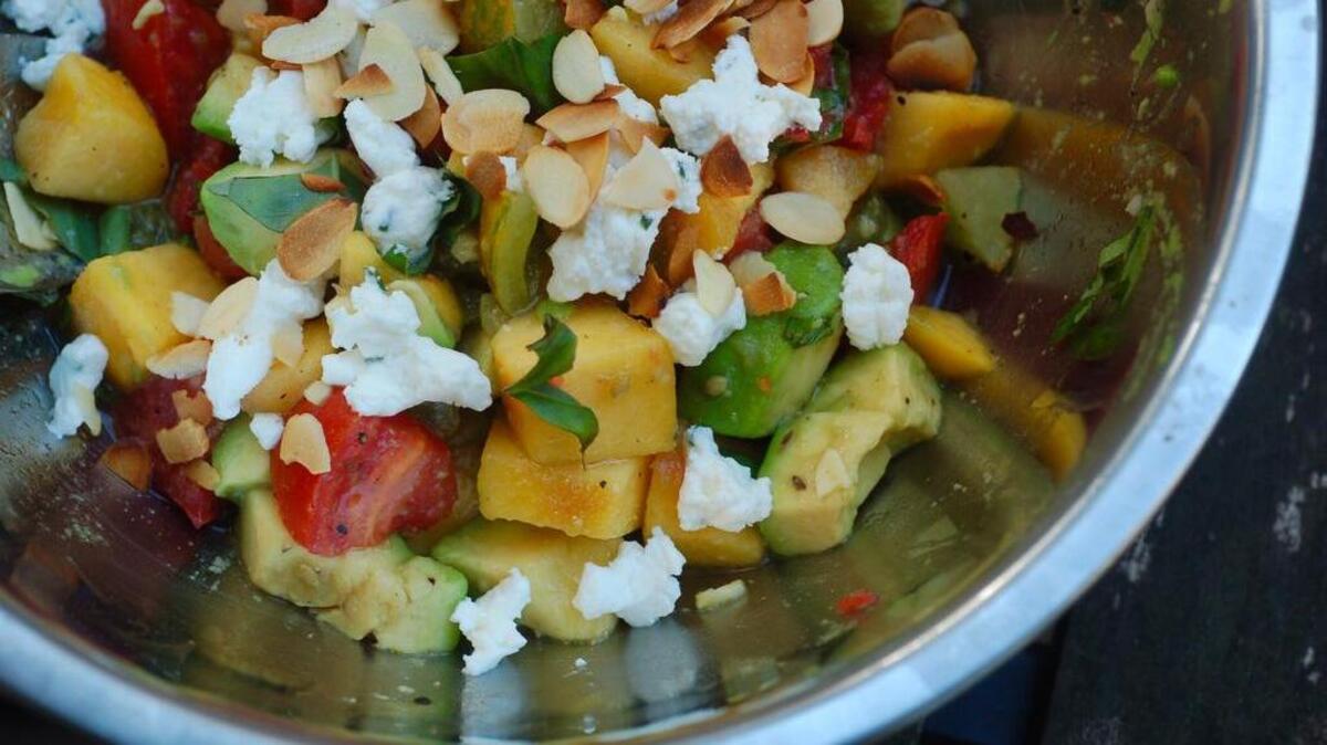 
Give peaches and tomatoes a proper send-off for the season with this hearty salad, satisfying enough on its own for a light dinner. 

