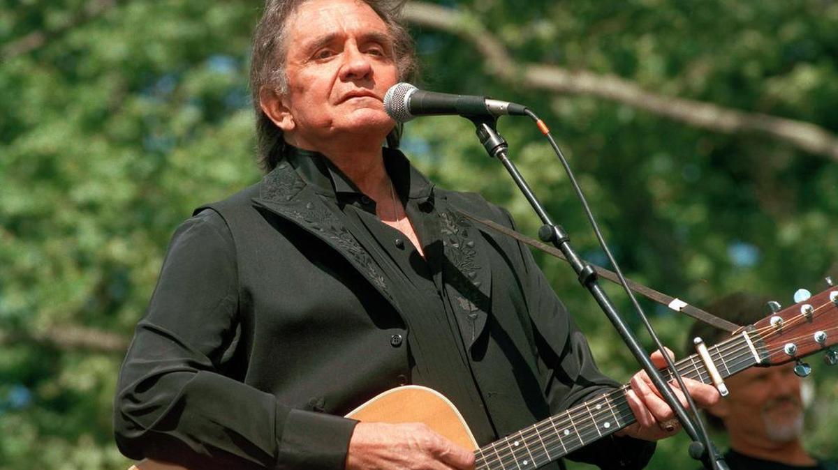 Johnny Cash performs at a benefit concert in Central Park in New York in May 1993.