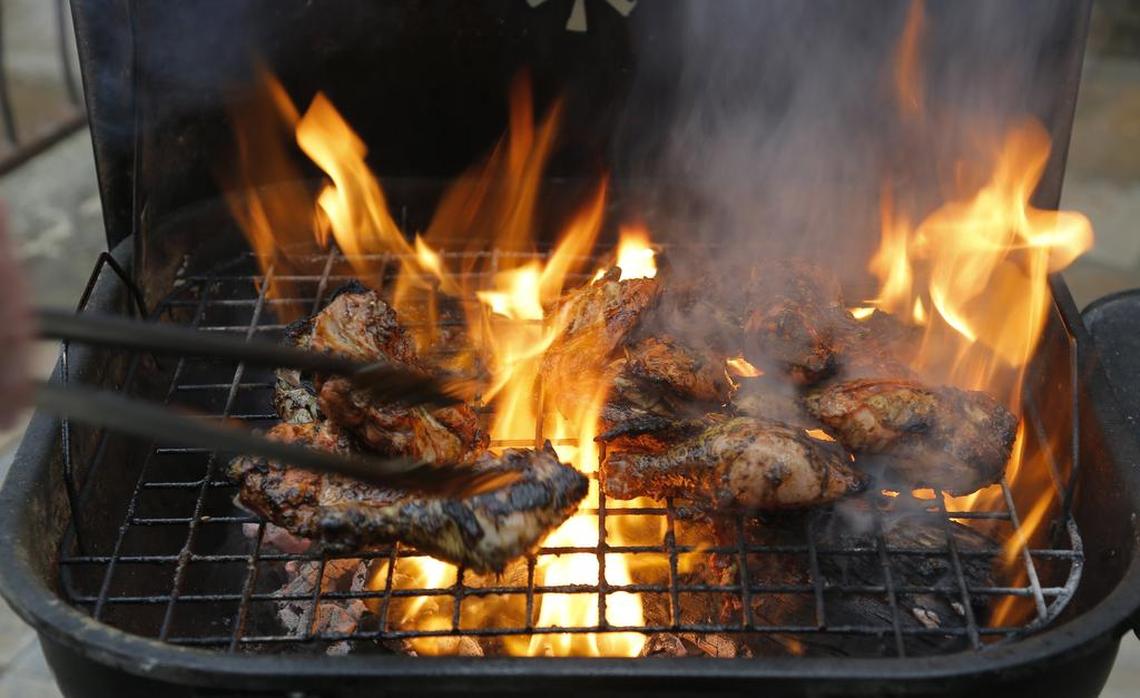 Michael Thomson grills jerk chicken at Michaels Cuisine Restaurant & Bar.