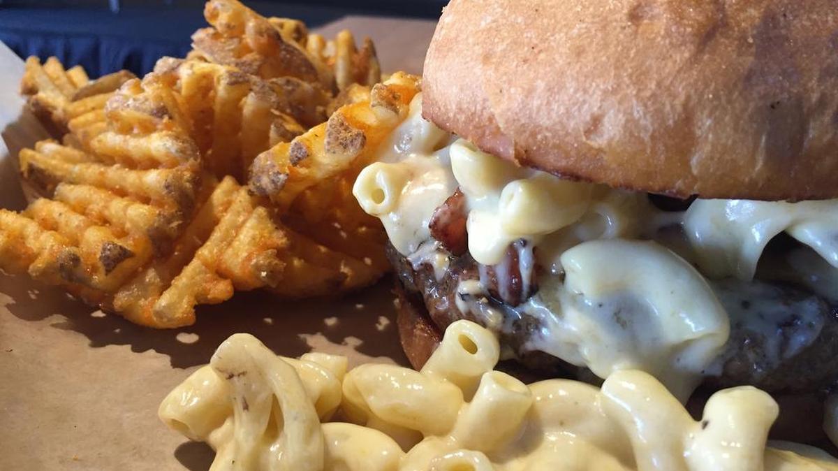The ‘Return of the Mac’ Burger at Varsity Tavern features a half-pound patty with a “heaping pile” of mac and cheese, extra cheddar cheese and smoked Applewood bacon