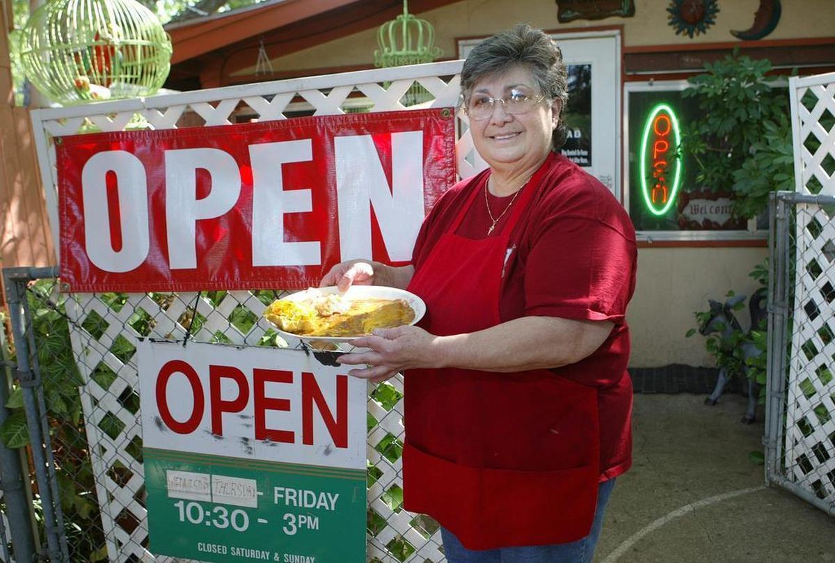 Virgie Martinez, owner of Mi Cocinita, holds one of the lunch specials in this 2006 photo.
