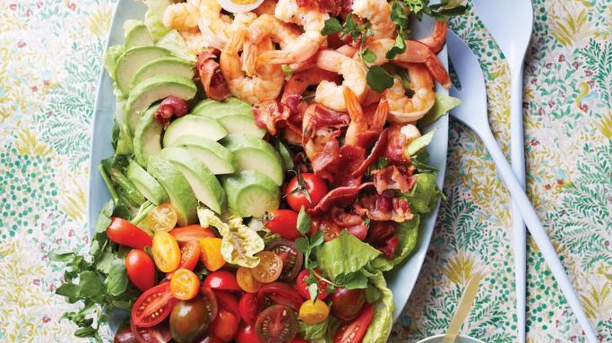 Toss the greens with half the dressing to bring out their flavor, then let everyone drizzle to taste.