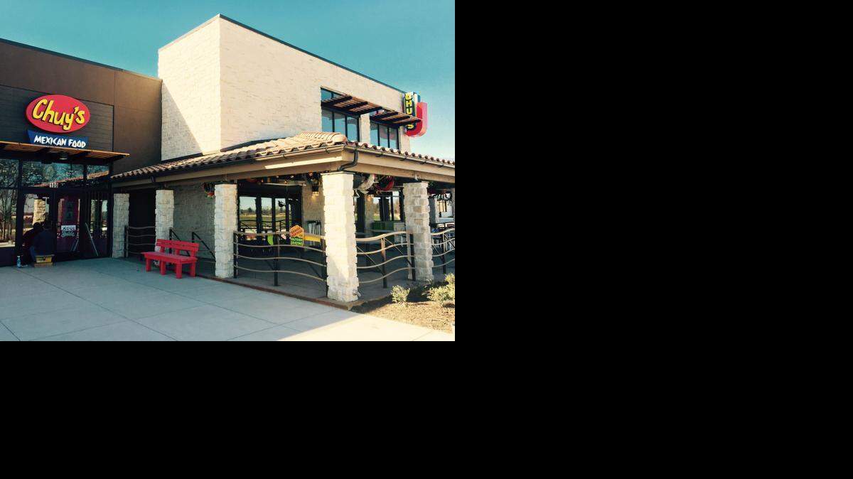 
A worker finishes the door glass for Chuy’s, now open in Southlake.
