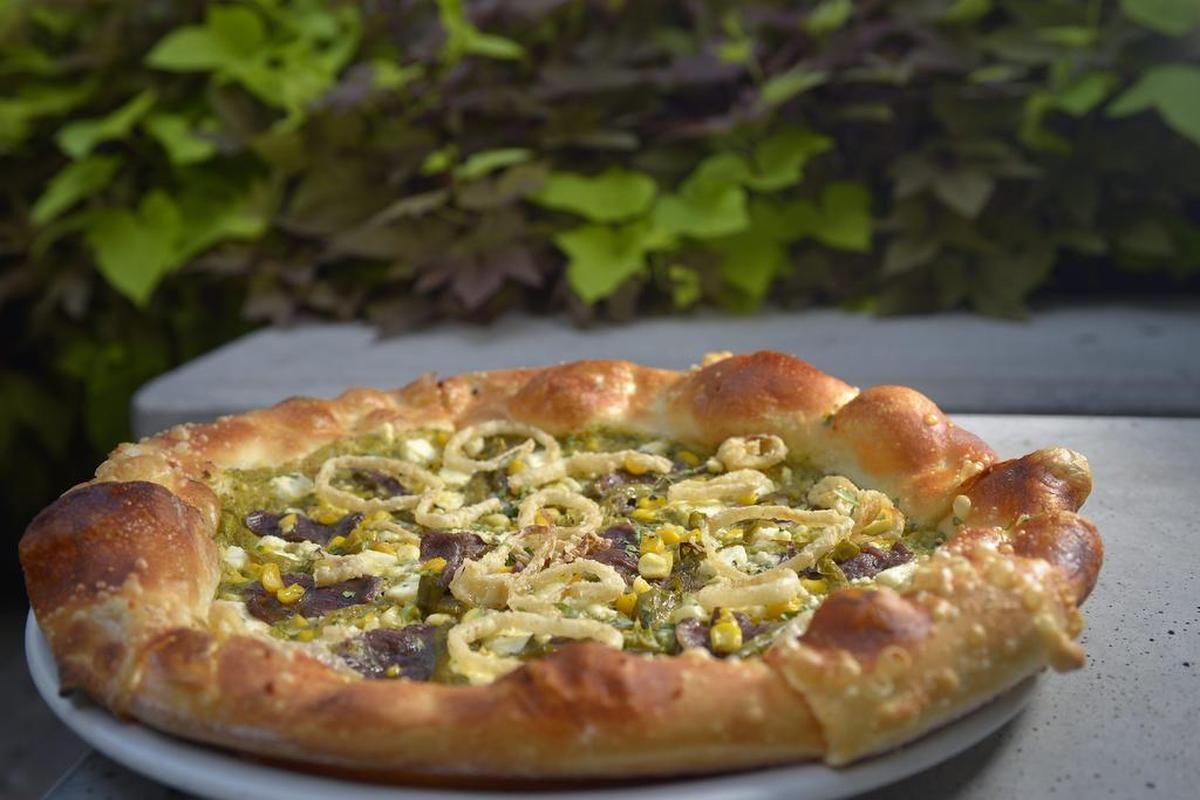 Fireside Pies was always popular in fall for its Hatch green chile pizzas, this one with steak, pesto, roasted corn and feta.
