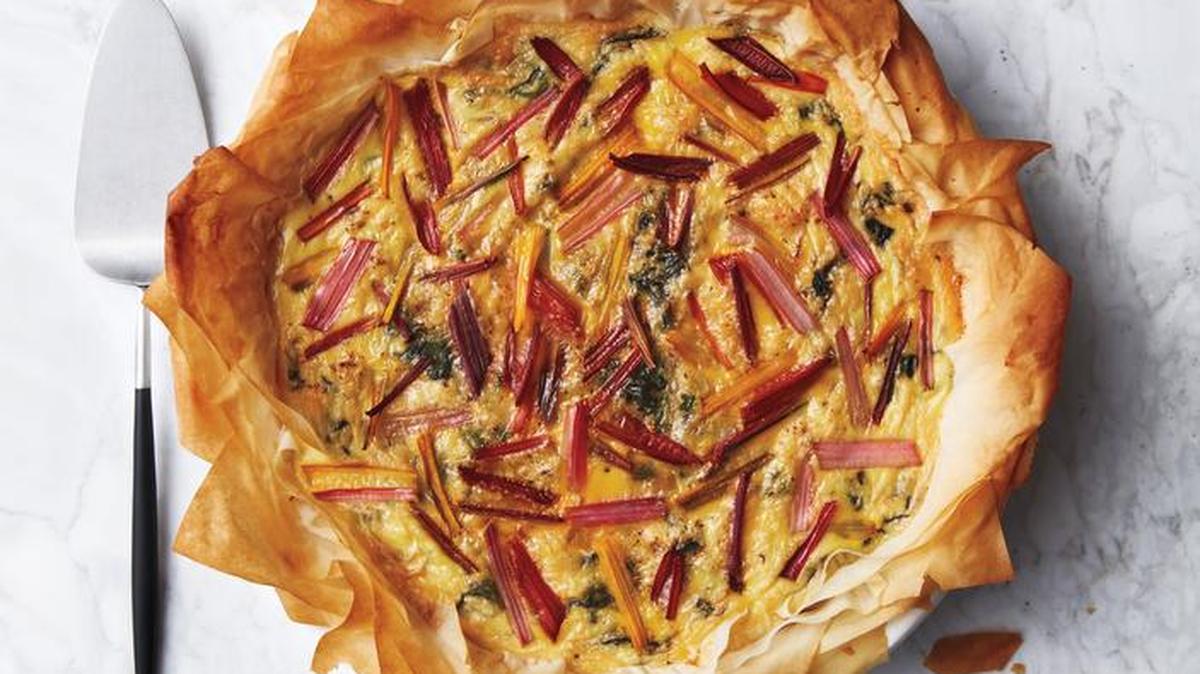 Good morning, sunshine! Sheets of phyllo dough form the crust of this rainbow-chard quiche and the untrimmed corners create burnished, flaky rays of the sun.